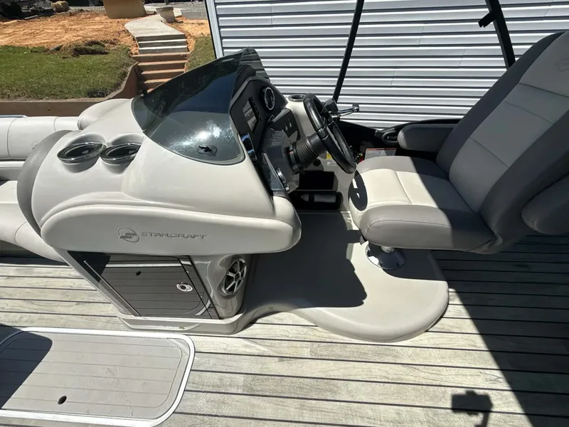 Slide: The Image of Interior of a 2017 Starcraft MX 25 boat with steering console. - 20