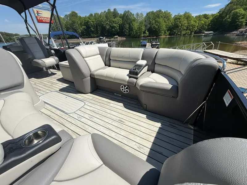 Slide: The Image of 2017 Starcraft MX 25 pontoon boat with gray leather seats by the lake. - 9