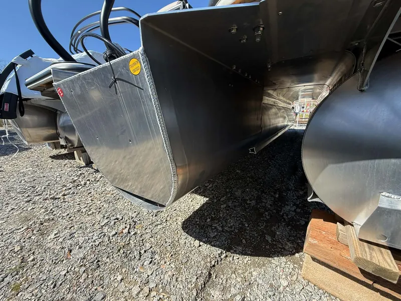 Slide: The Image of 2026 Bentley Pontoons Legacy 223 Navigator underside on gravel. - 3