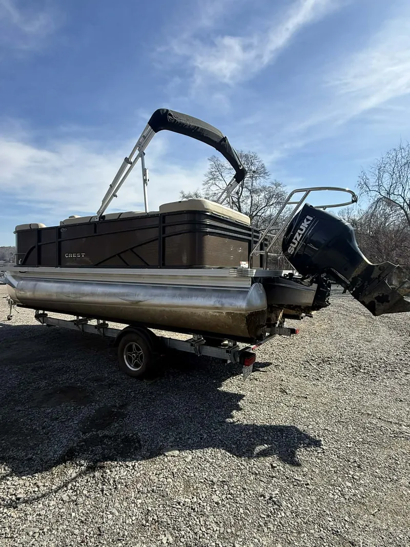 Slide: The Image of 2024 Crest Classic LX 200 pontoon boat on trailer. - 4