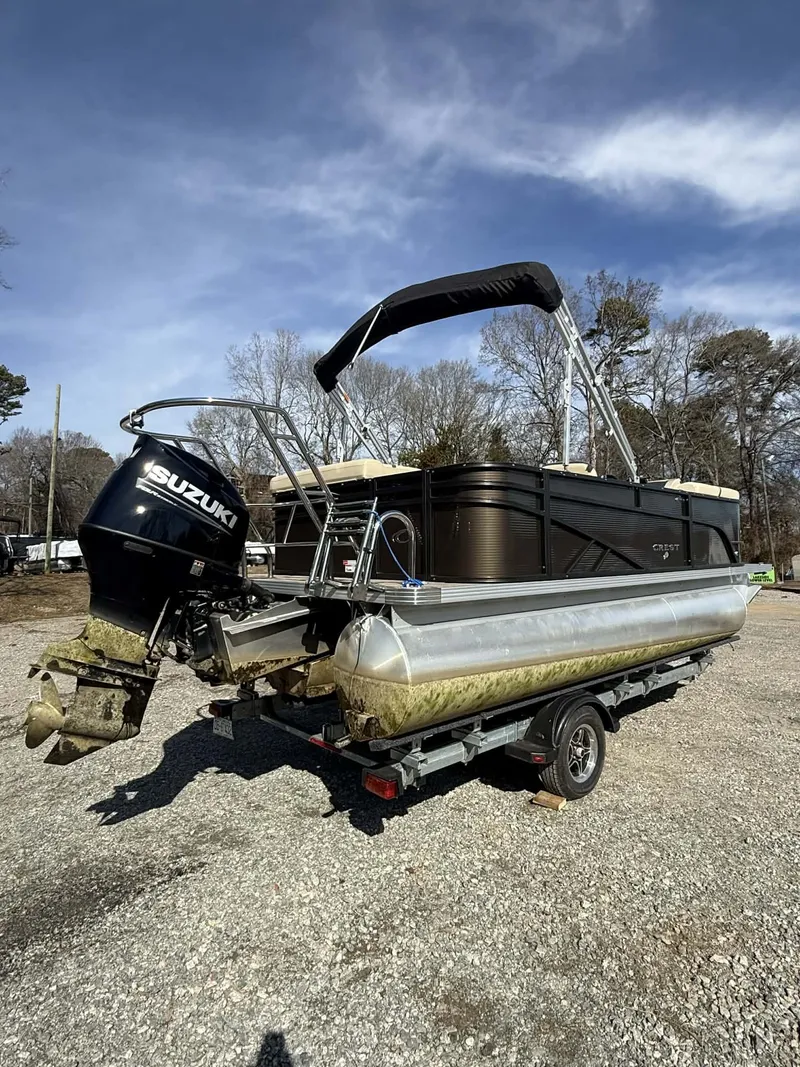 Slide: The Image of 2024 Crest Classic LX 200 pontoon boat with Suzuki motor on trailer. - 9