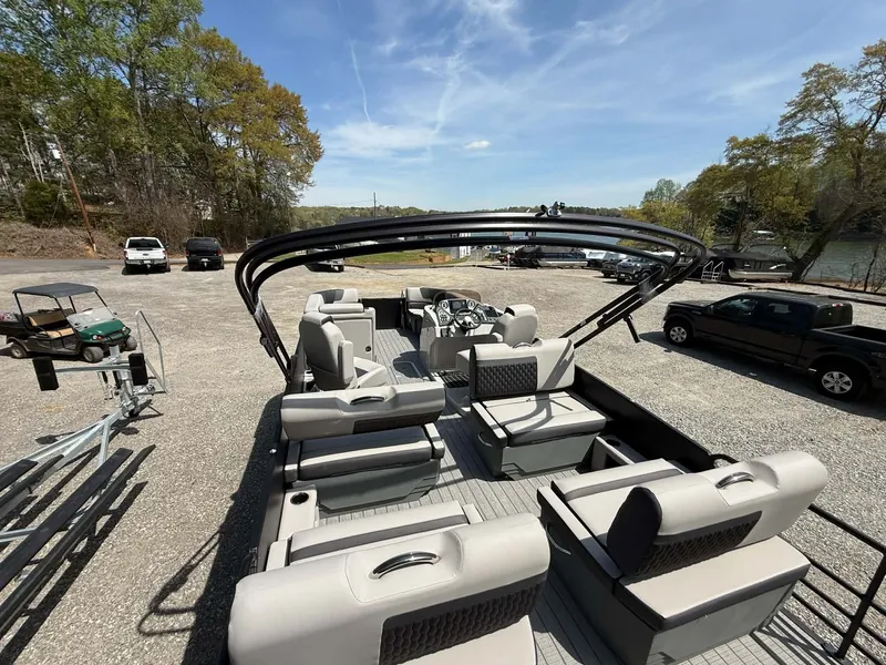 Slide: The Image of Sylvan L-3 RLZ 2026 pontoon boat with luxurious interior on parking lot. - 30