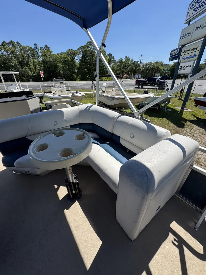 Slide: The Image of 2013 Lowe X214 Fish pontoon boat with seating area and table. - 12