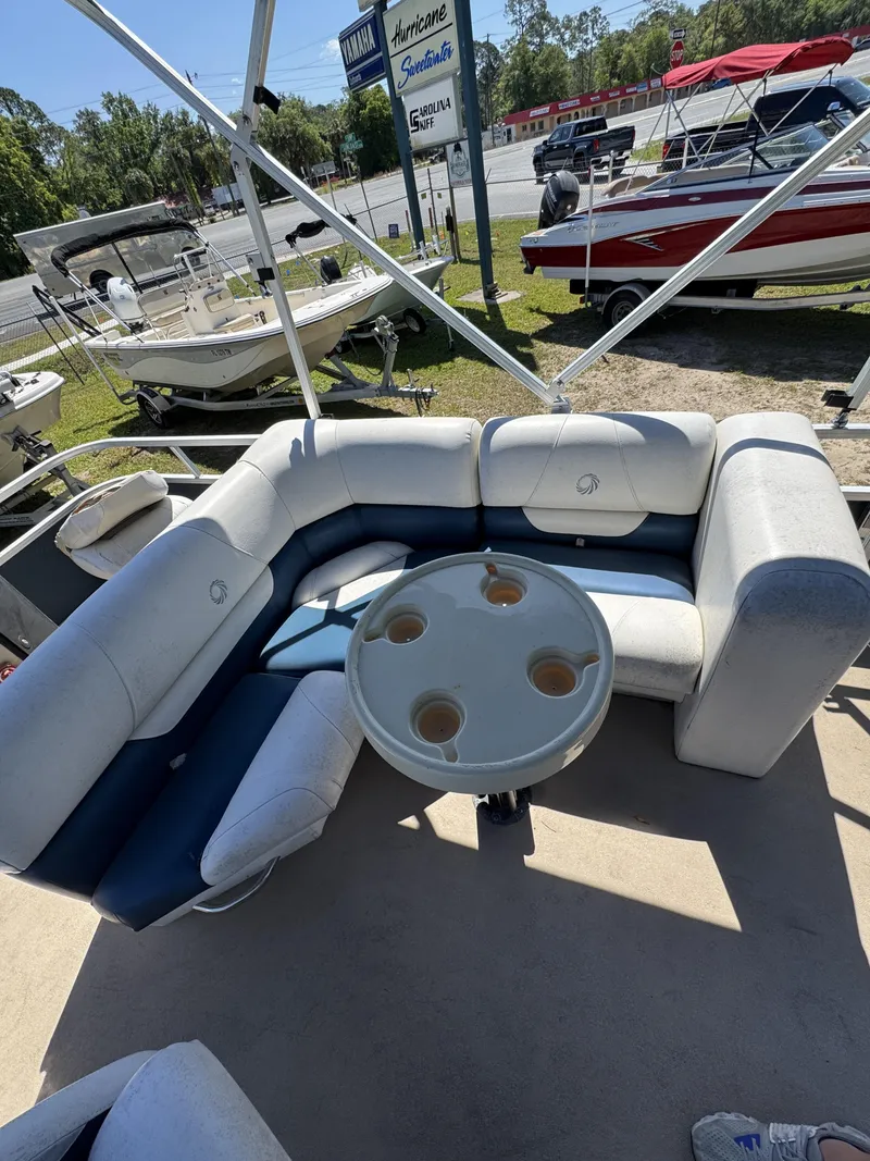 Slide: The Image of Lowe X214 Fish 2013 with seating area and table on a boat. - 13