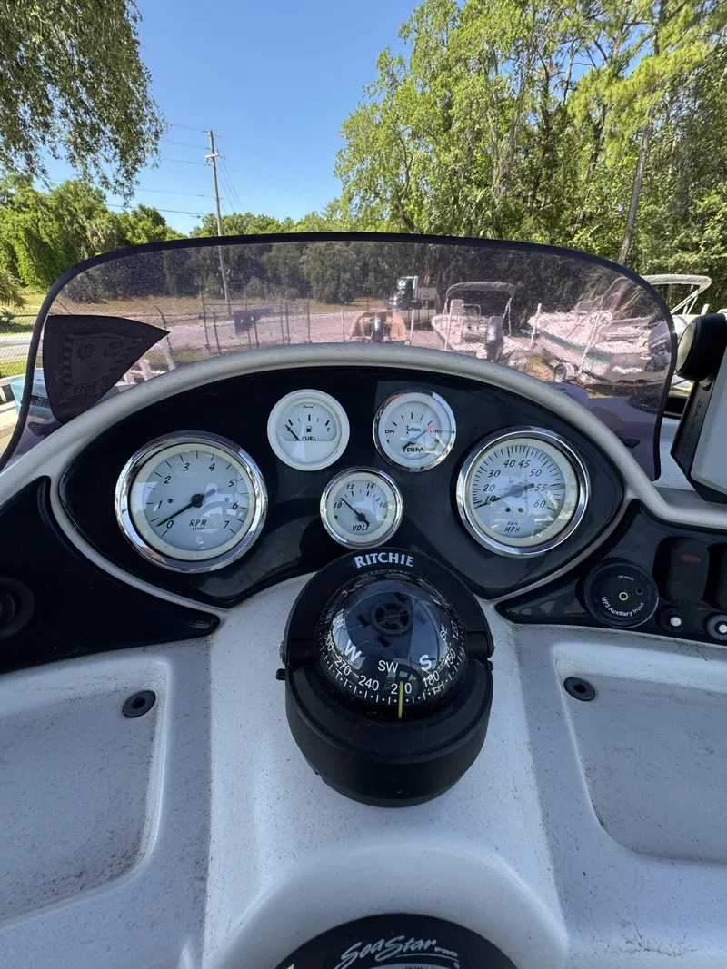 Slide: The Image of Dashboard of a 2013 Lowe X214 Fish boat with compass and gauges. - 17