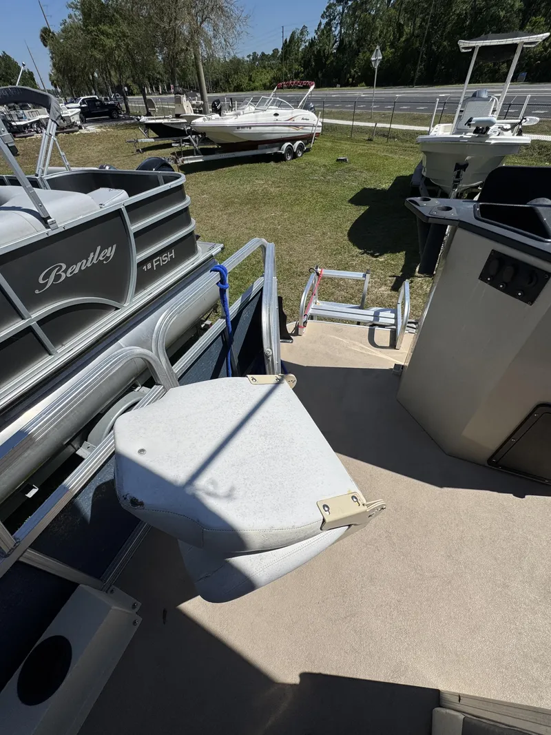 Slide: The Image of 2013 Lowe X214 Fish boat in a parking area with other boats. - 19