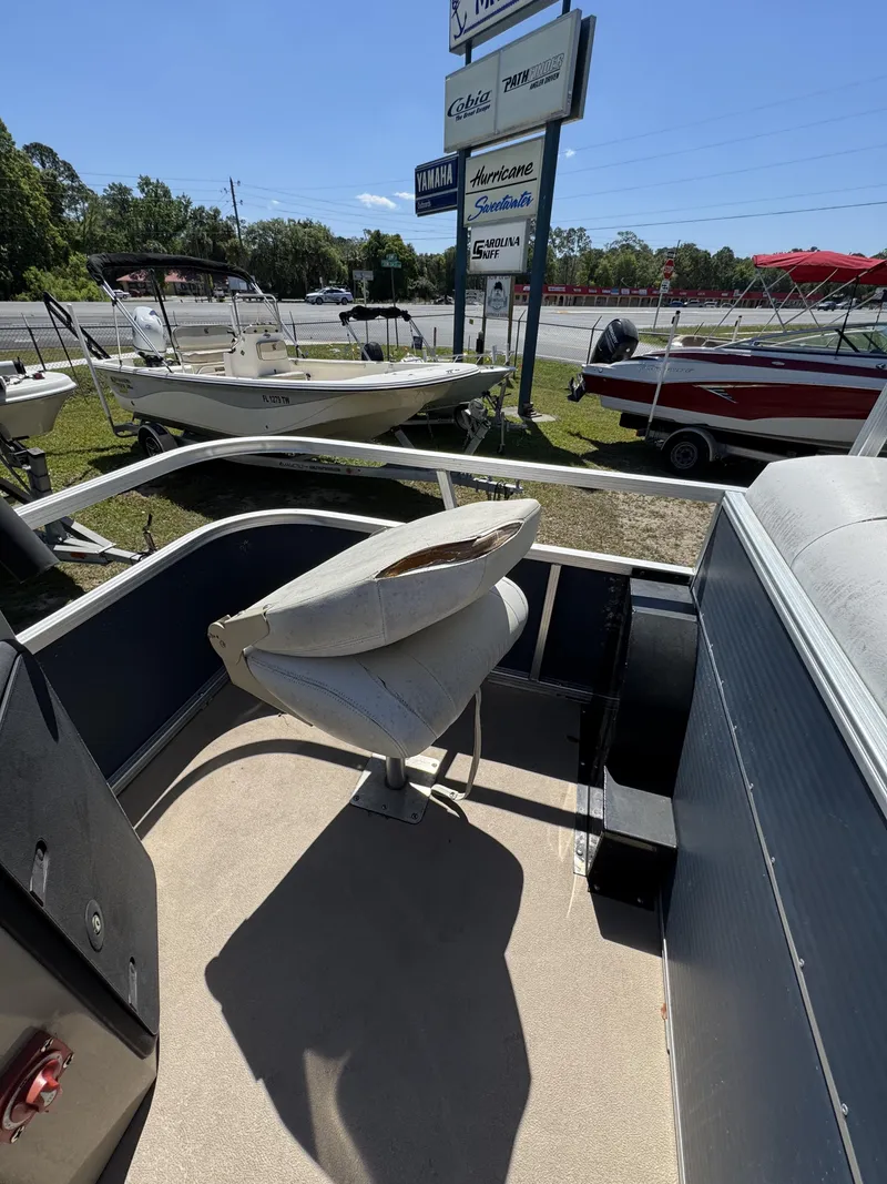 Slide: The Image of 2013 Lowe X214 Fish boat with seat, displayed outdoors. - 21