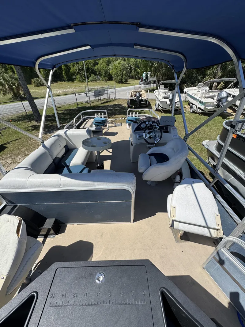 Slide: The Image of Interior of a 2013 Lowe X214 Fish pontoon boat with blue seating. - 22