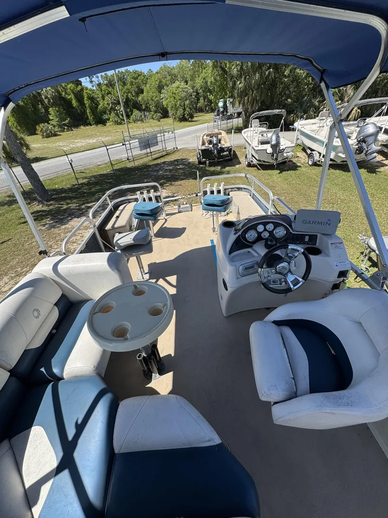 Slide: The Image of Interior view of a 2013 Lowe X214 Fish pontoon boat with helm console. - 23