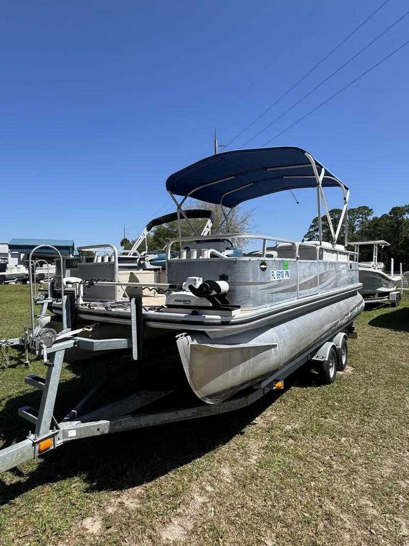Slide: The Image of 2013 Lowe X214 Fish pontoon boat on trailer under sunny skies. - 25