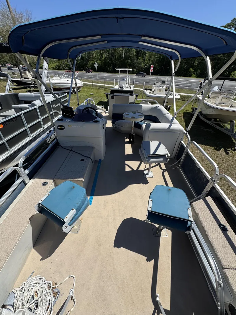 Slide: The Image of 2013 Lowe X214 Fish pontoon boat with blue canopy. - 27