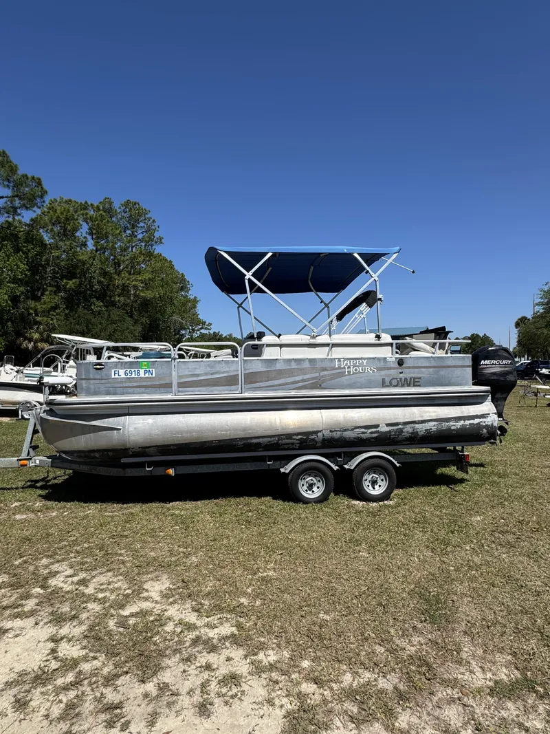 Slide: The Image of 2013 Lowe X214 Fish pontoon boat parked outdoors on trailer. - 4