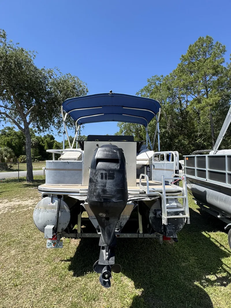 Slide: The Image of 2013 Lowe X214 Fish boat with outboard motor parked outdoors. - 8