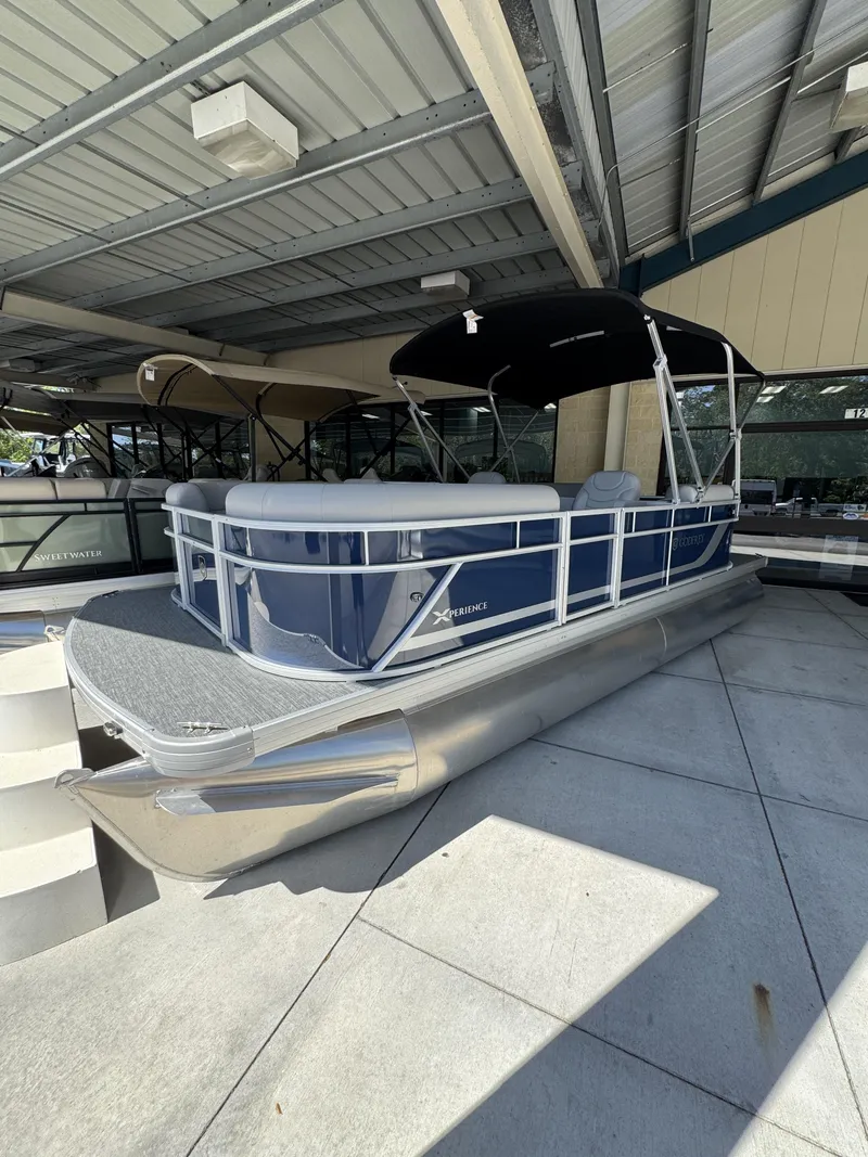 Slide: The Image of 2026 Sweetwater EX2086SBX pontoon boat under covered area. - 17