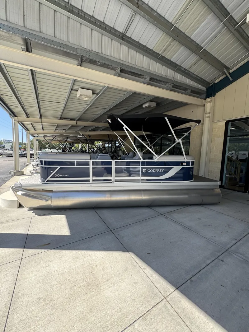 Slide: The Image of 2026 Sweetwater EX2086SBX pontoon boat under canopy. - 18