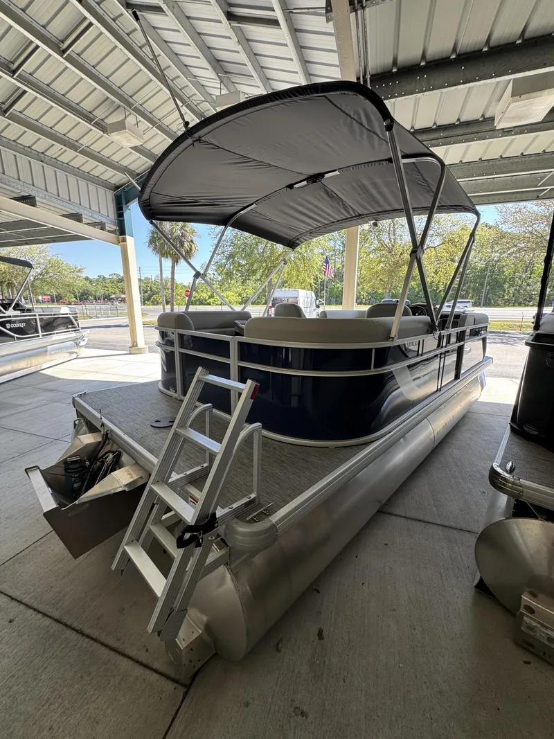 Slide: The Image of Sweetwater EX2086SBX 2026 pontoon boat with canopy in a marina. - 3