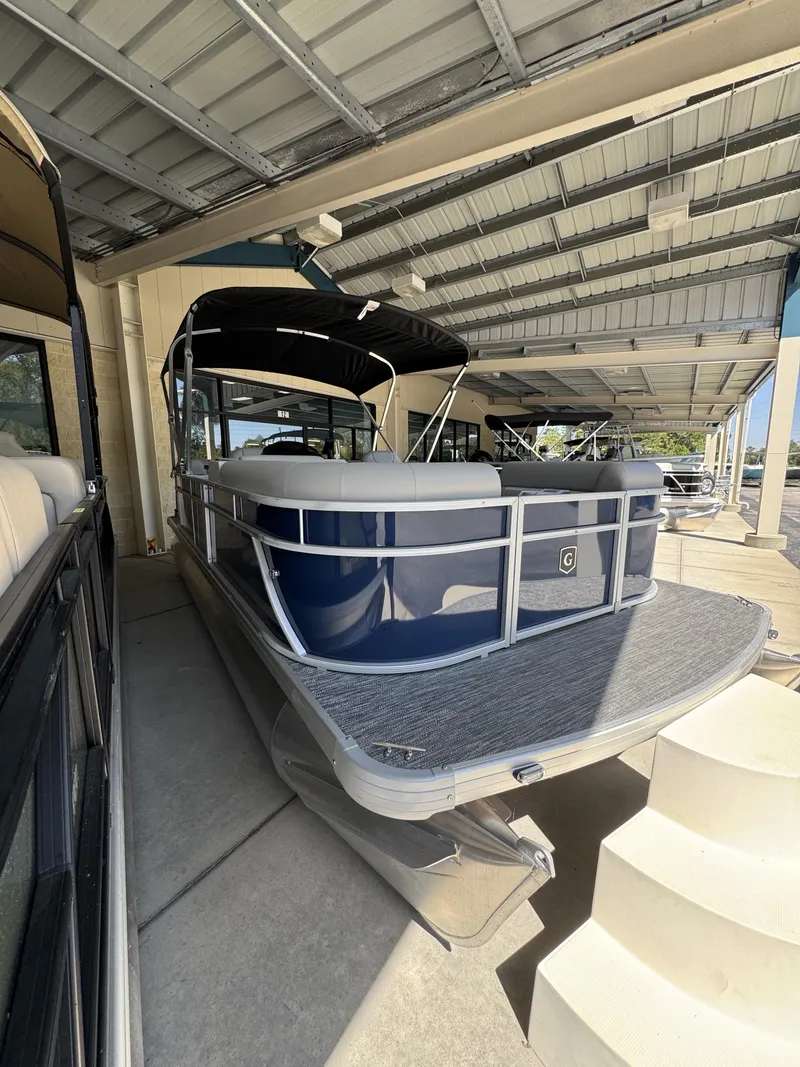 Slide: The Image of 2026 Sweetwater EX2086SBX pontoon boat under covered area. - 4
