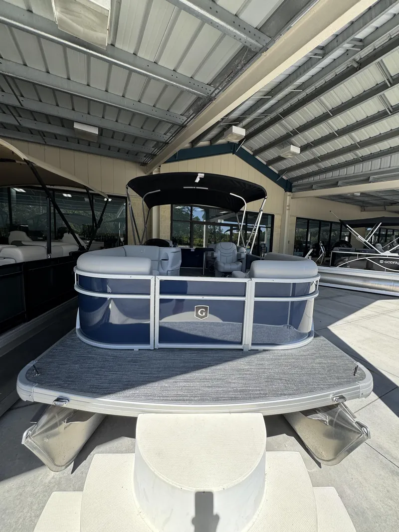 Slide: The Image of 2026 Sweetwater EX2086SBX pontoon boat in covered showroom. - 5