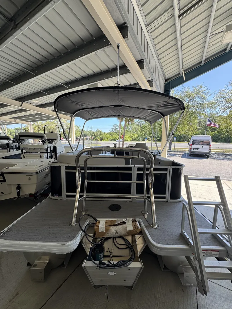 Slide: The Image of 2026 Sweetwater SW2086CSE pontoon boat under covered area. - 5