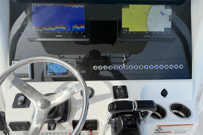 Slide: The Image of Edgewater 262CC 2021 boat dashboard with Garmin displays and Yamaha controls. - 30