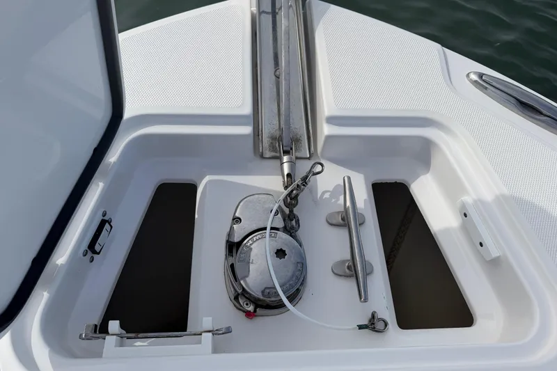 Slide: The Image of Anchor compartment of 2021 Edgewater 262CC boat, featuring a windlass system. - 36