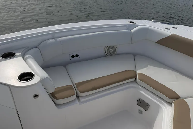 Slide: The Image of Luxurious seating area on a 2021 Edgewater 262CC boat, featuring cup holders and comfortable cushions. - 37