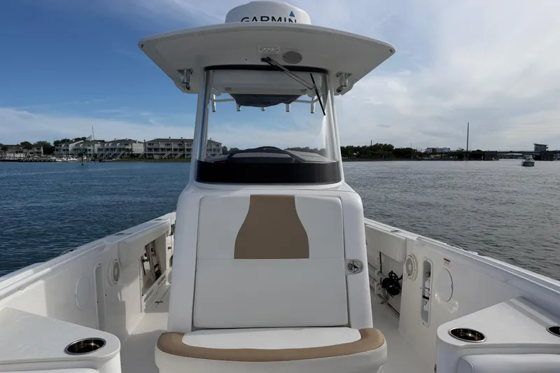 Slide: The Image of 2021 Edgewater 262CC boat on water, featuring a sleek console and seating area. - 39