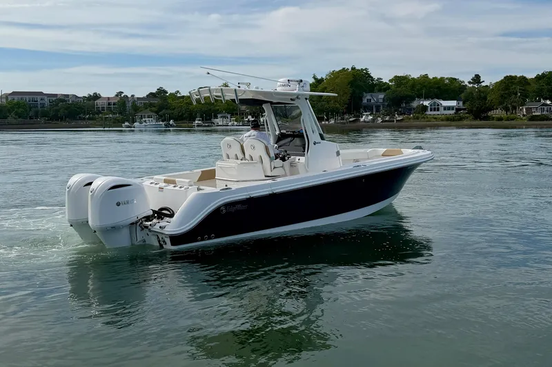 Slide: The Image of 2021 Edgewater 262CC boat with twin Yamaha engines on calm water. - 4