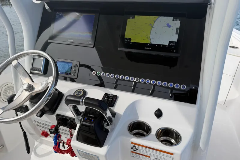 Slide: The Image of Helm of 2021 Edgewater 262CC boat with navigation screens and controls. - 41