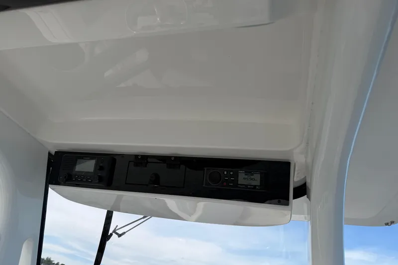 Slide: The Image of 2021 Edgewater 262CC boat console with electronic controls and radio system. - 42