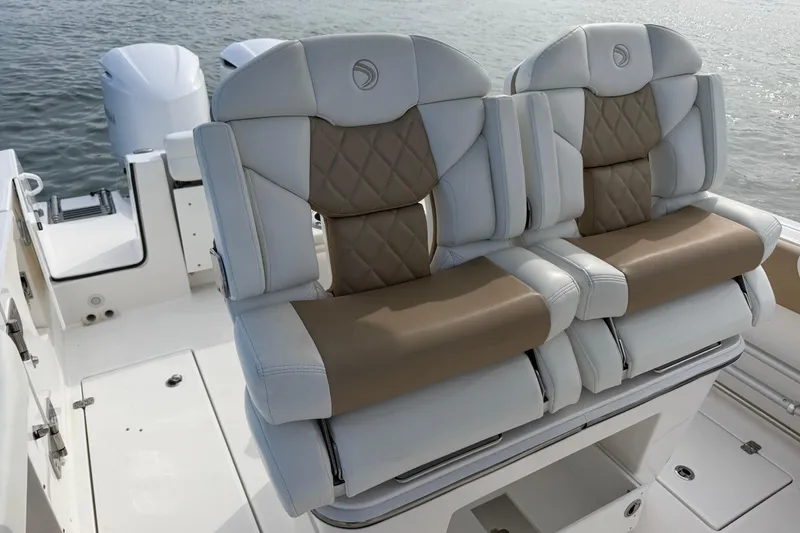 Slide: The Image of Luxury seating on 2021 Edgewater 262CC boat with dual engines in background. - 44