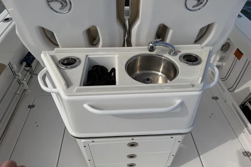 Slide: The Image of Edgewater 262CC 2021 boat with sink and storage compartments on deck. - 46