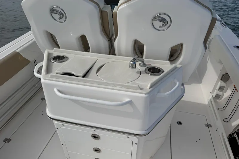 Slide: The Image of 2021 Edgewater 262CC boat interior with sink and seating area. - 47