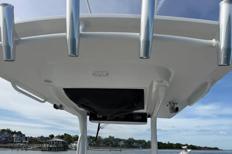 Slide: The Image of 2021 Edgewater 262CC boat's T-top with rod holders and electronics. - 48