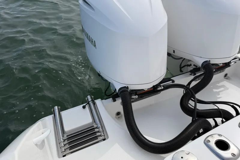Slide: The Image of Edgewater 262CC 2021 boat with dual Yamaha outboard motors and swim ladder. - 52