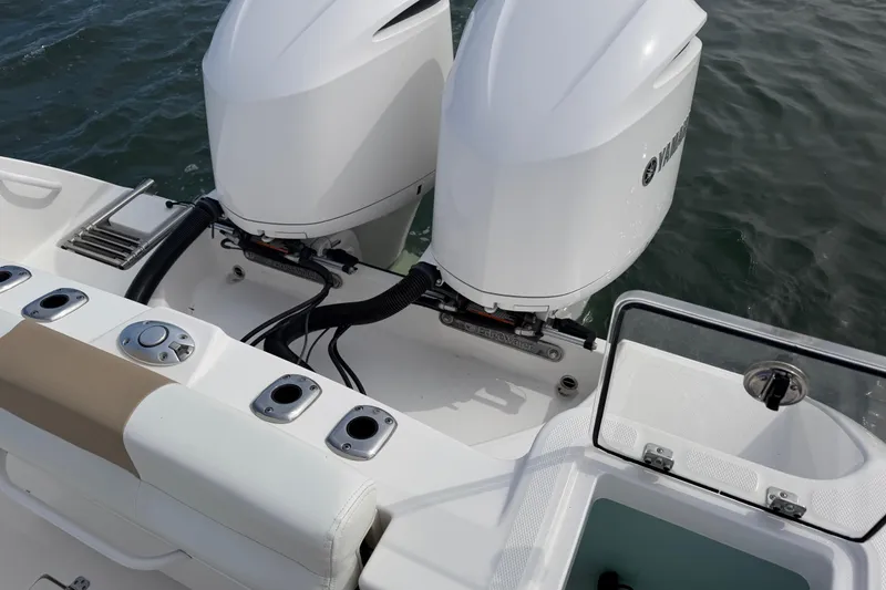 Slide: The Image of Edgewater 262CC 2021 boat with dual outboard engines on water. - 54