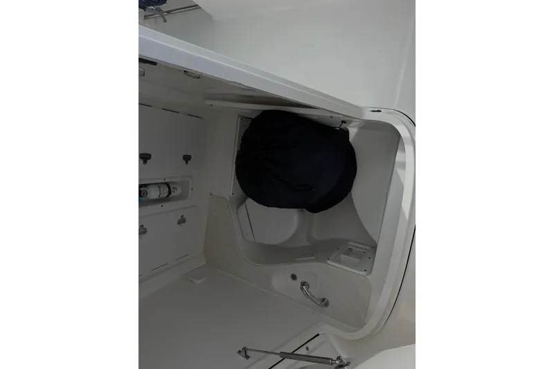 Slide: The Image of Interior view of 2021 Edgewater 262CC boat compartment with storage and equipment. - 59