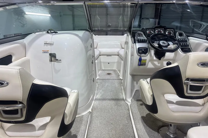 Slide: The Image of Interior of a 2009 Chaparral 236 SSX boat, featuring sleek seating and modern dashboard controls. - 13