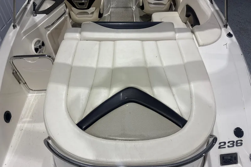 Slide: The Image of 2009 Chaparral 236 SSX boat interior with white seating and sleek design. - 14