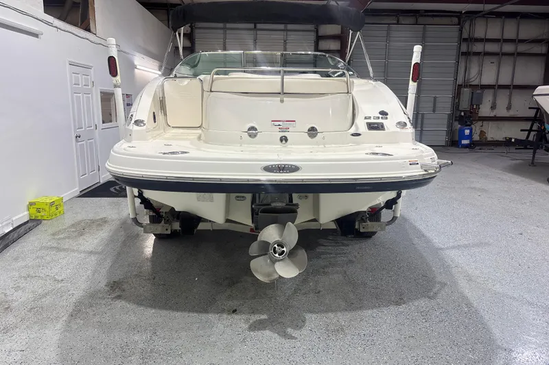 Slide: The Image of 2009 Chaparral 236 SSX boat in a garage, rear view showing propeller and swim platform. - 4