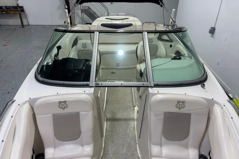 Slide: The Image of 2009 Chaparral 236 SSX boat interior with white seating and windshield. - 5