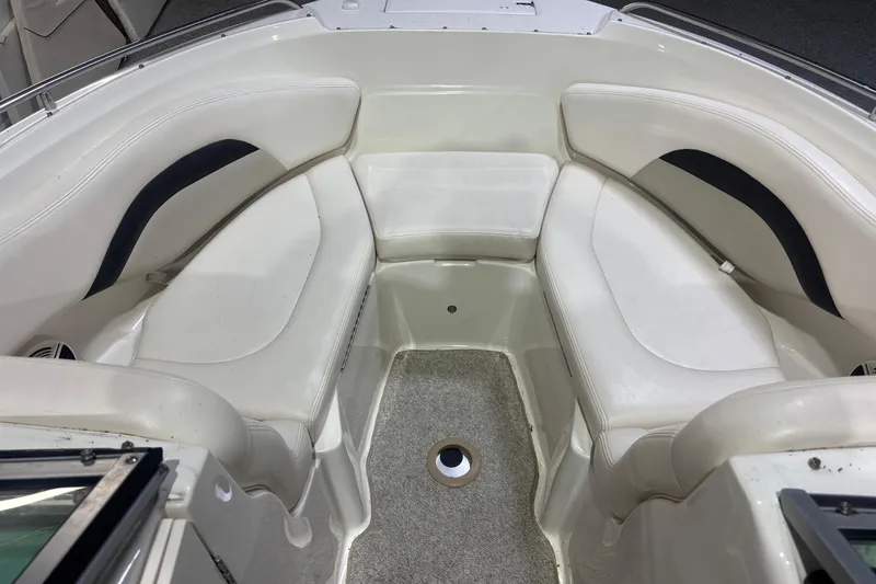 Slide: The Image of 2009 Chaparral 236 SSX boat interior with white seating and carpeted floor. - 6