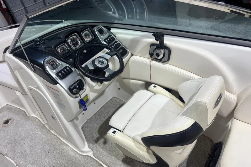 Slide: The Image of 2009 Chaparral 236 SSX boat cockpit with steering wheel and control panel. - 7