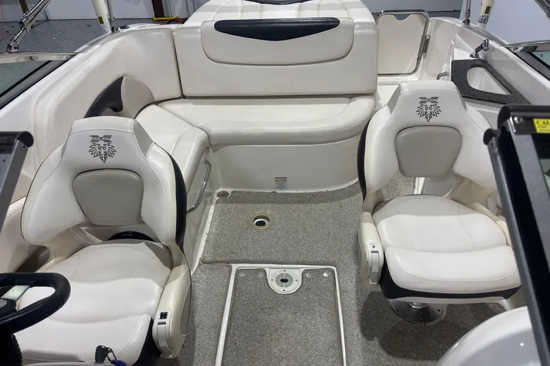 Slide: The Image of 2009 Chaparral 236 SSX boat interior with white seating and carpeted flooring. - 9