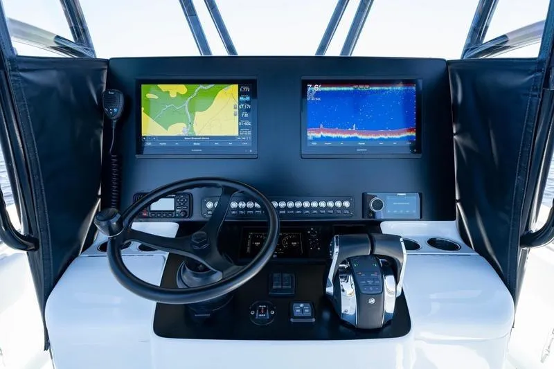 Slide: The Image of 2022 Contender 32 ST boat dashboard with navigation screens and controls. - 14