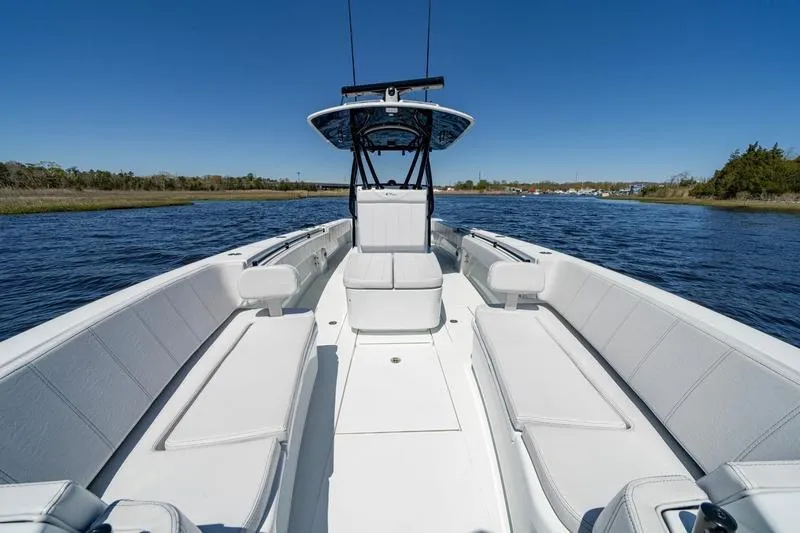 Slide: The Image of 2022 Contender 32 ST boat with spacious seating on calm water. - 19