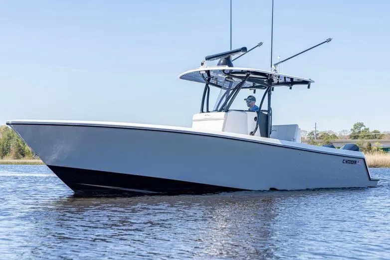 Slide: The Image of 2022 Contender 32 ST boat on calm water, featuring sleek design and modern features. - 7