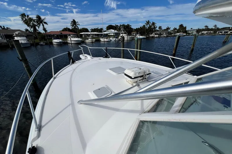Slide: The Image of 2007 Luhrs 41 Hardtop boat docked in a marina with palm trees. - 14