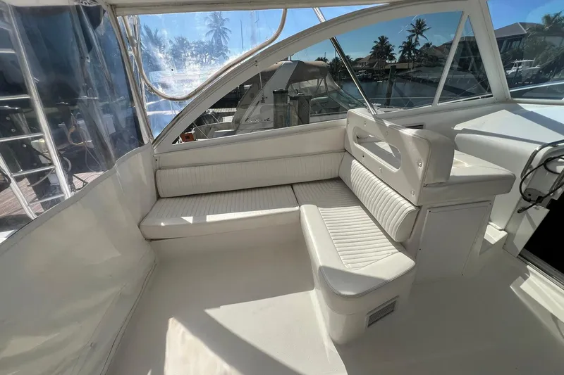 Slide: The Image of 2007 Luhrs 41 Hardtop boat interior with white seating and clear windows. - 16