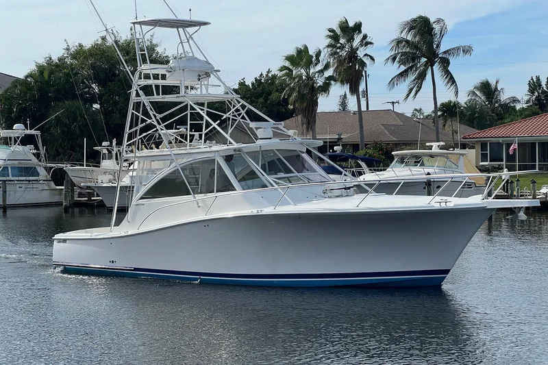 Slide: The Image of 2007 Luhrs 41 Hardtop yacht docked in a serene marina setting. - 3